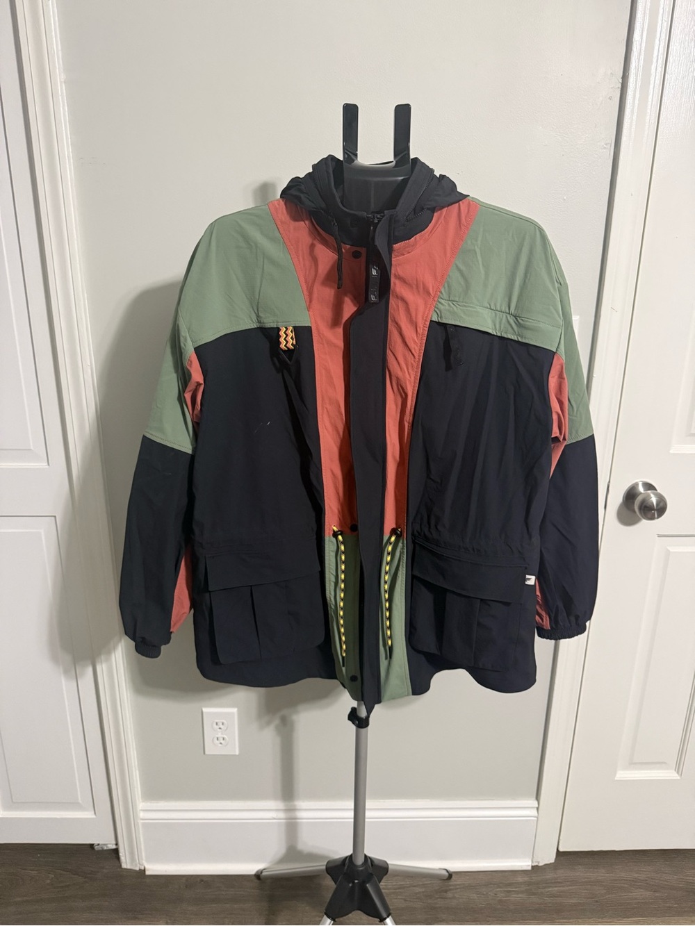 Fabletics Colorblock Hooded Raincoat in Black, Green & Coral